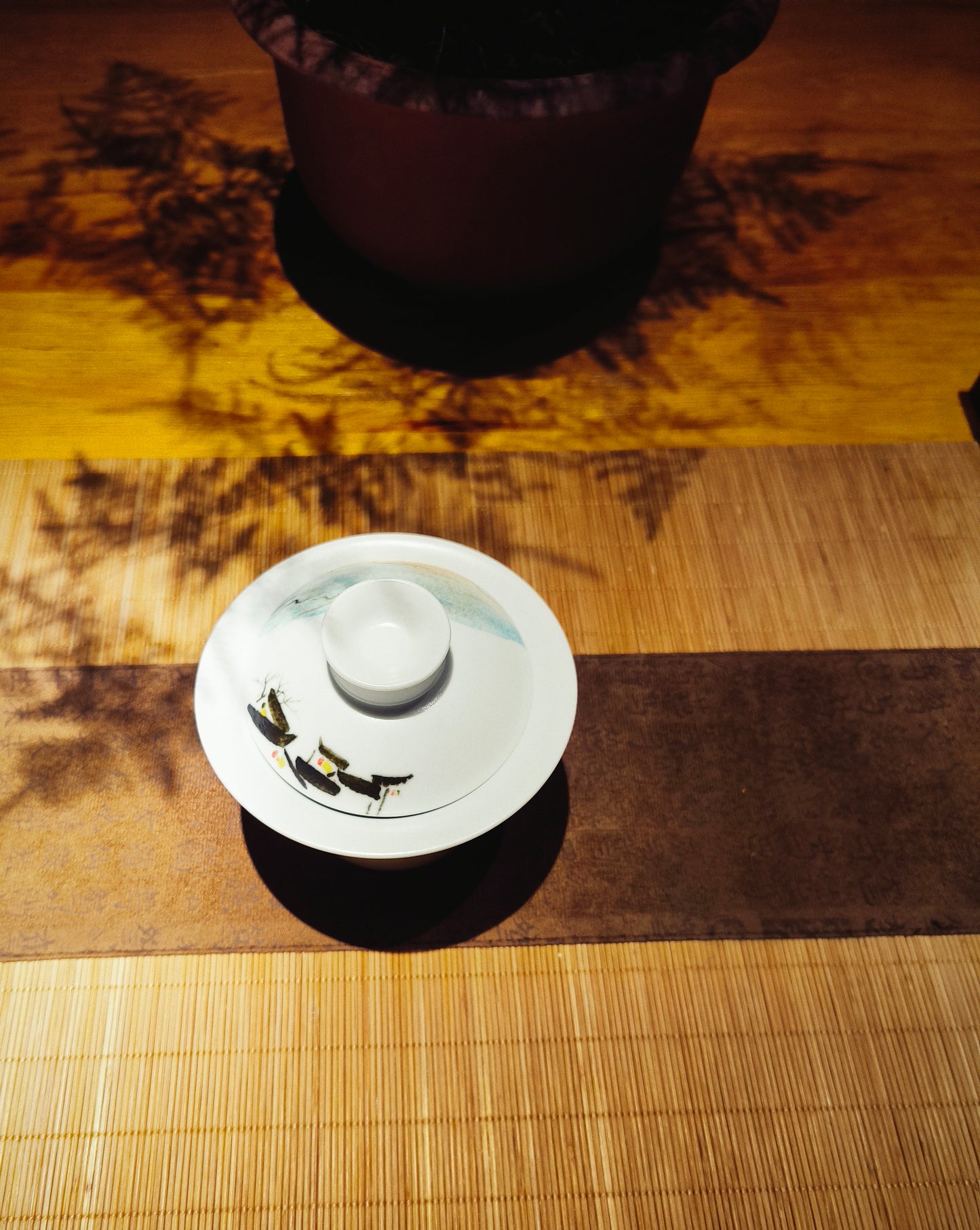 Zoomed out view of abstract hand-painted design on matte underglaze gaiwan