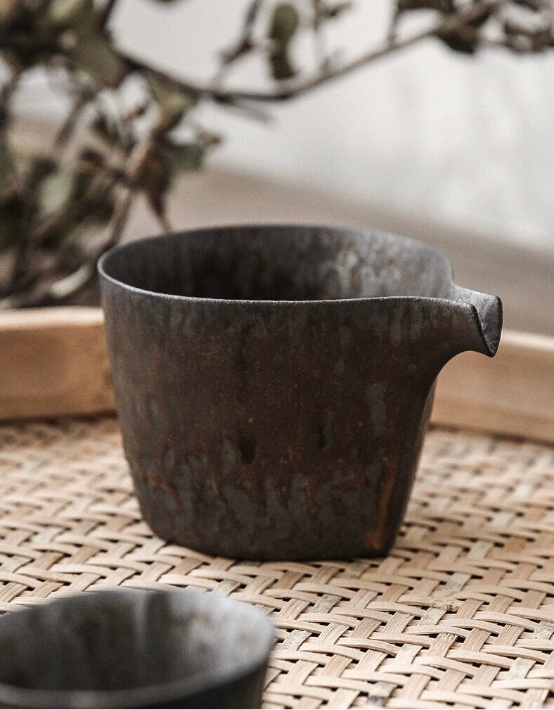 Side view of retro ceramic creamer jug showing unique spout design