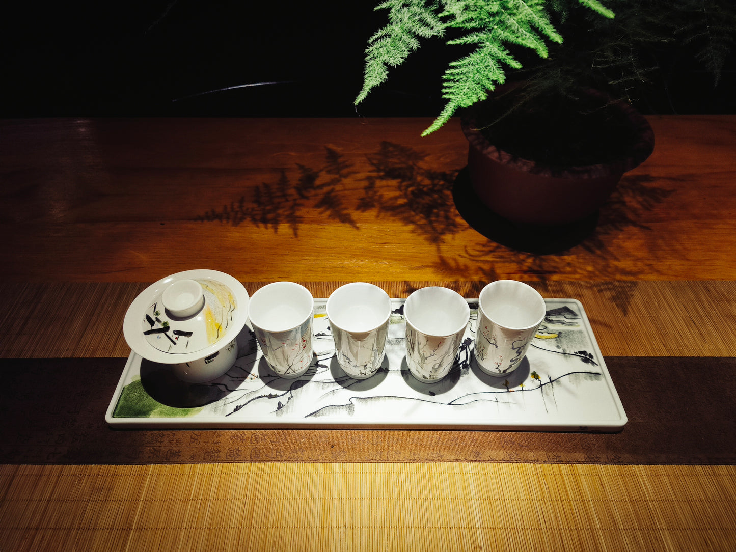 Ceramic tea set with hand-painted tray featuring abstract Chinese art brushstrokes_top view