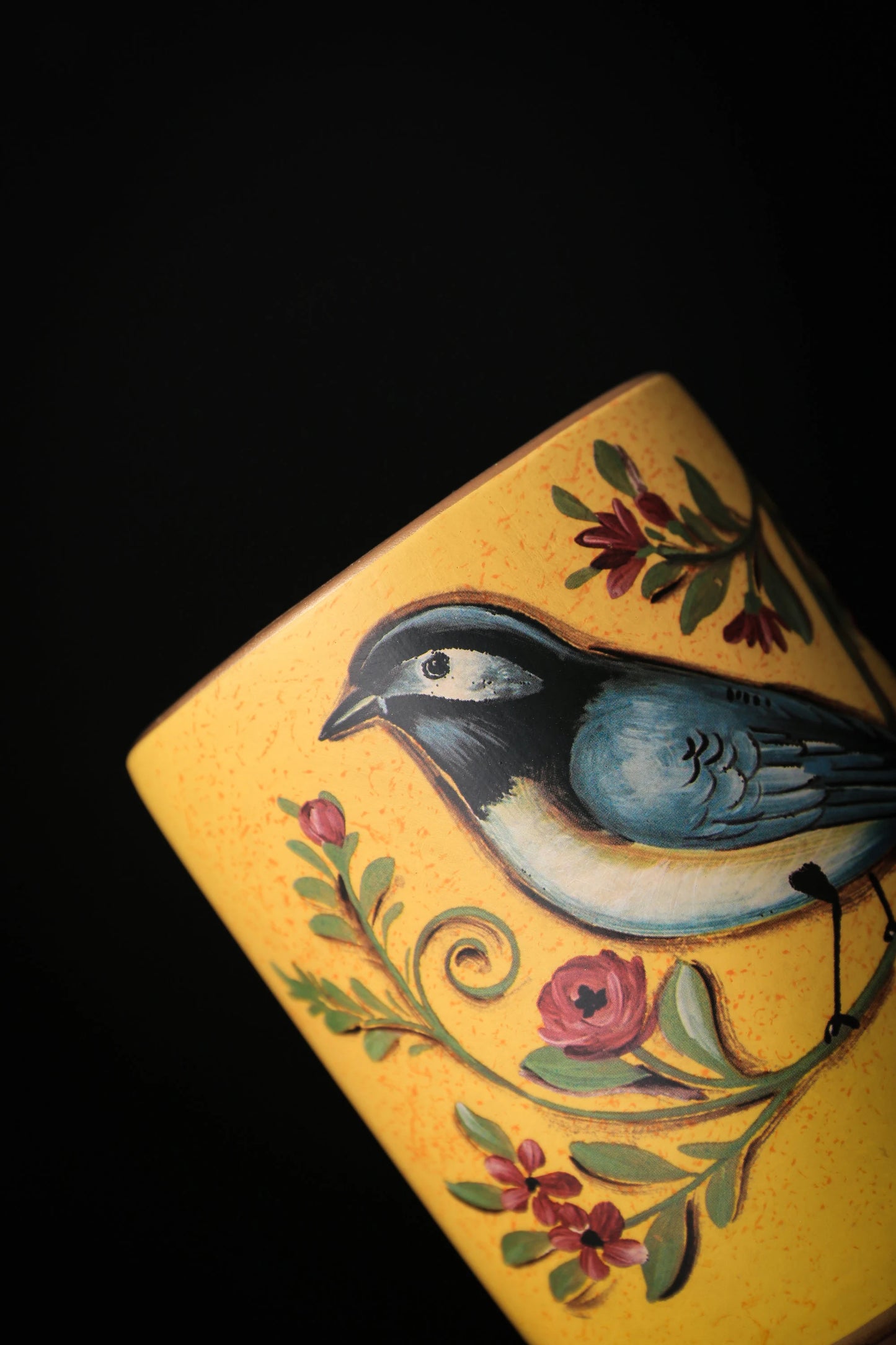 Close-up of traditional ceramic jar with bird illustration and retro glaze finish_yellow version