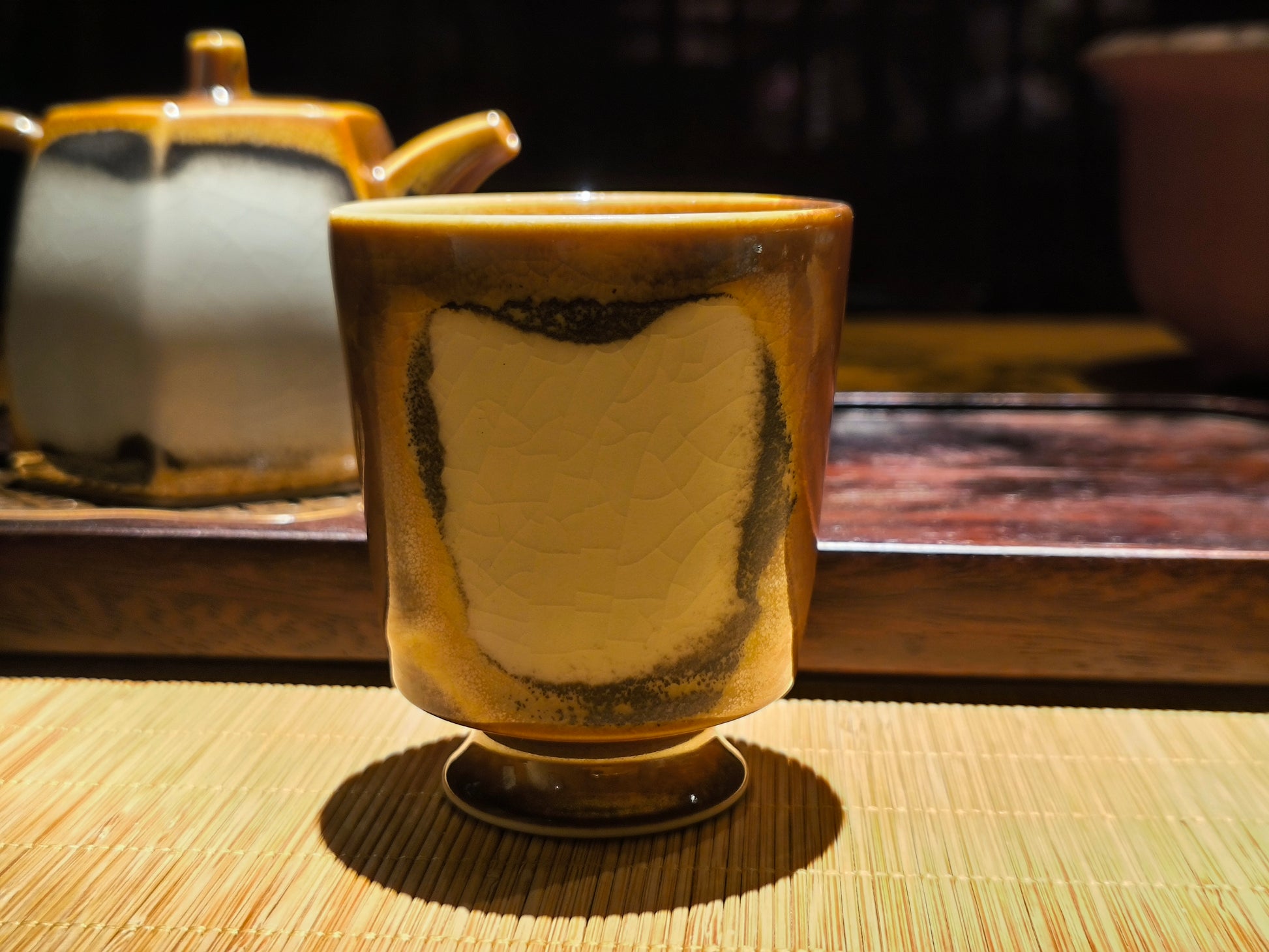 Handmade ceramic teacup with retro glaze finish in warm lighting