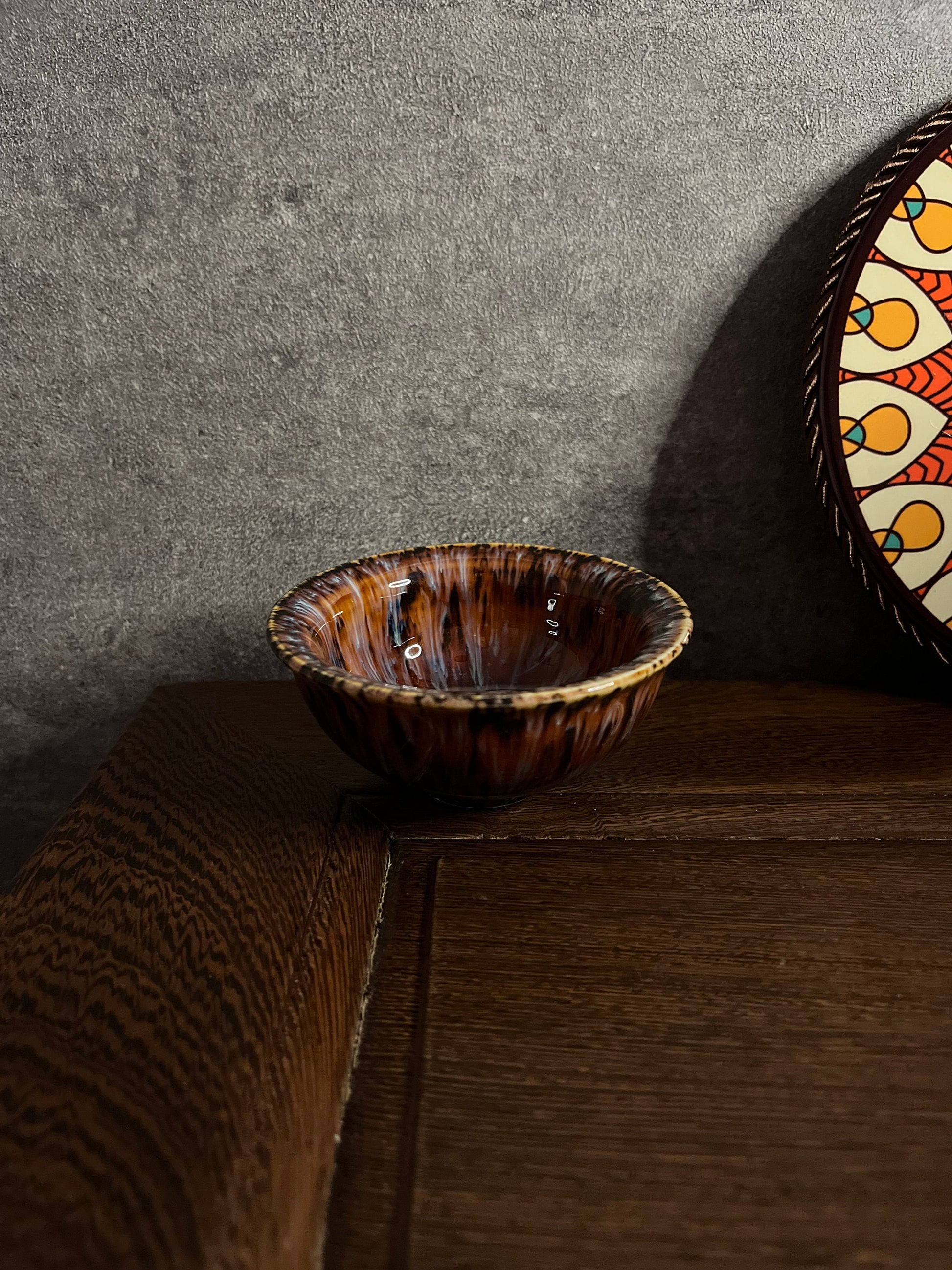 Ceramic Persian-style tea cup with red-brown glaze and golden flower pattern by Home Relax Studio