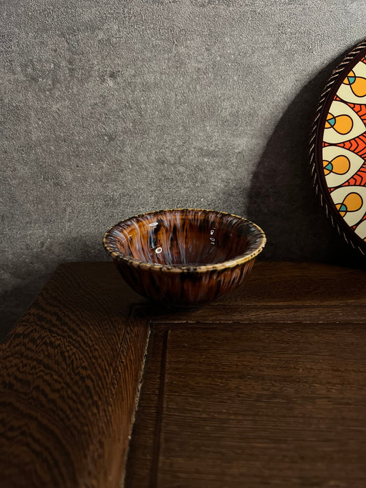 Ceramic Persian-style tea cup with red-brown glaze and golden flower pattern by Home Relax Studio