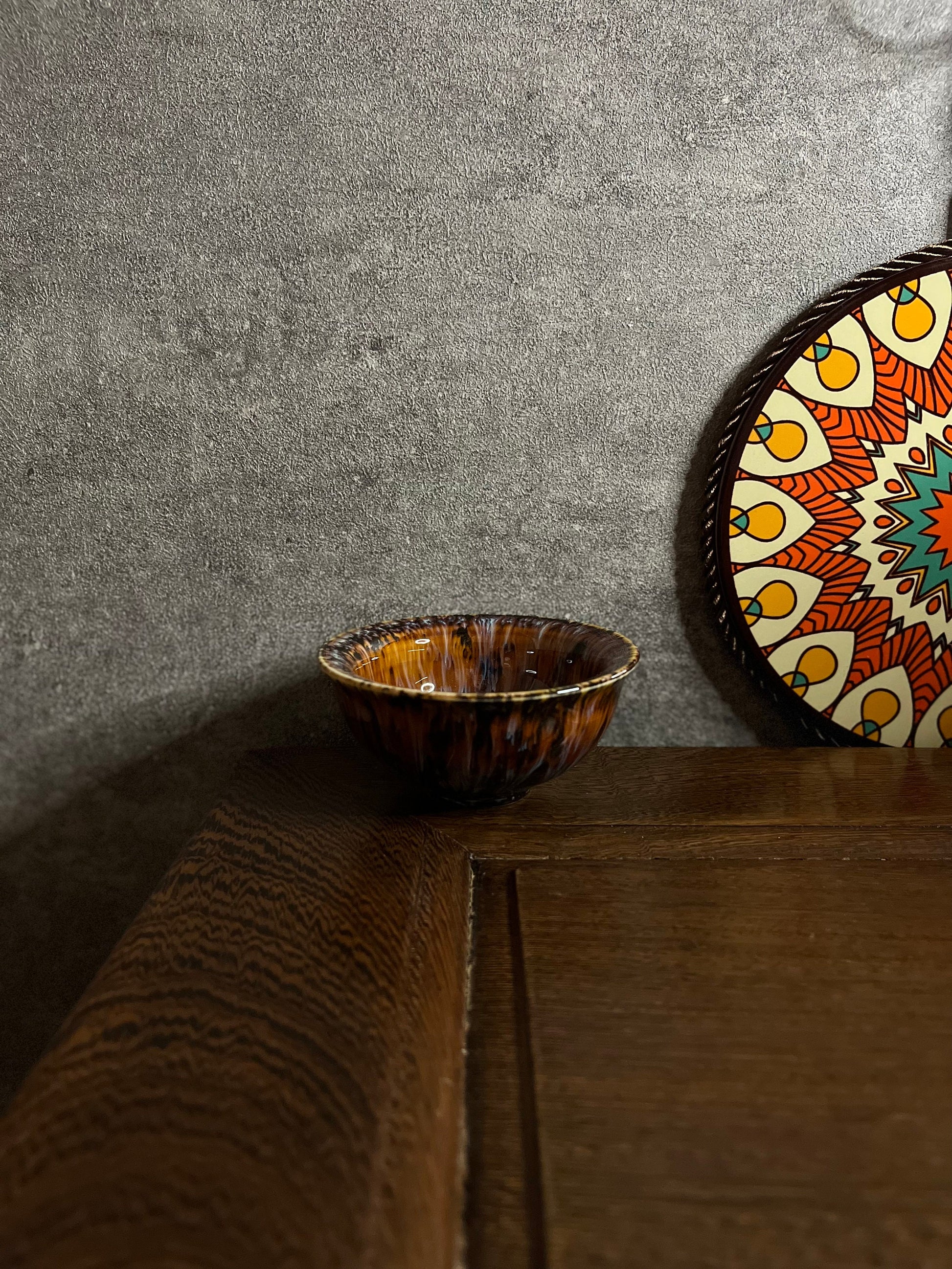 Close-up of ceramic gift tea cup with intricate golden floral details