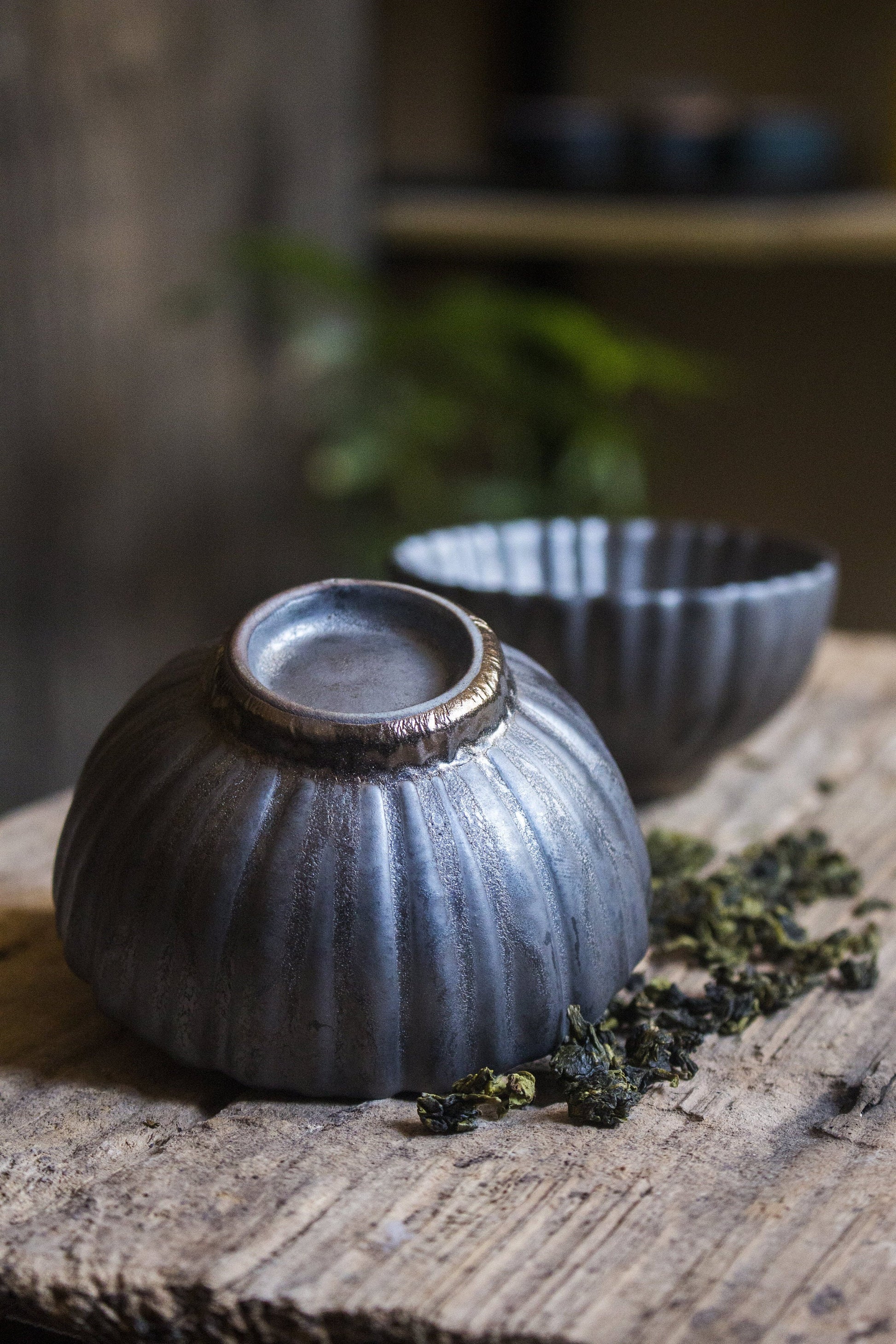 Close-up of retro-style ceramic tea cup flower petal stripped style wine sake drinkware with unique glaze details