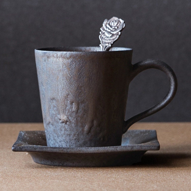 Close-up of unique artisan coffee cup with square plate