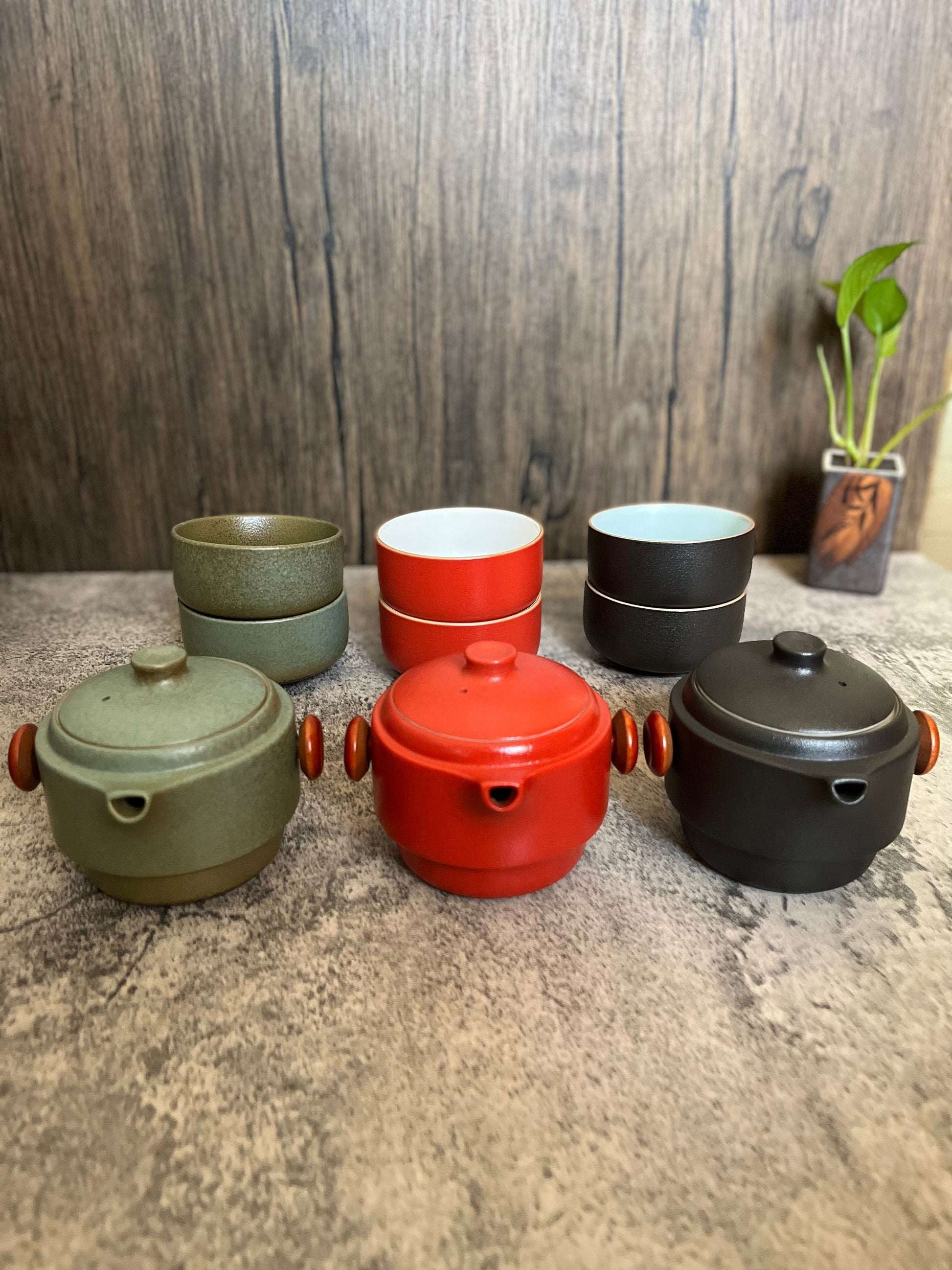 Compact ceramic teapot and tea cups for travel or outdoor use_displaying the unfolded and unlayered sets which has one kettle an two cups 