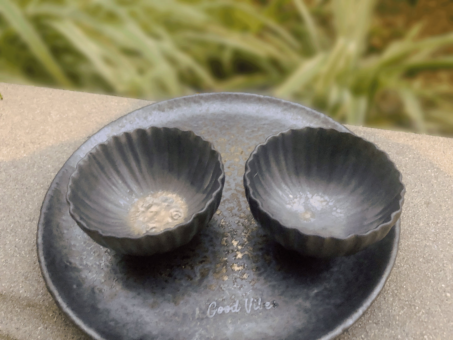 Industrial style ceramic flower-shaped cups with textured finish on a matching tray that is engraved with good omen words "Good Vibes"