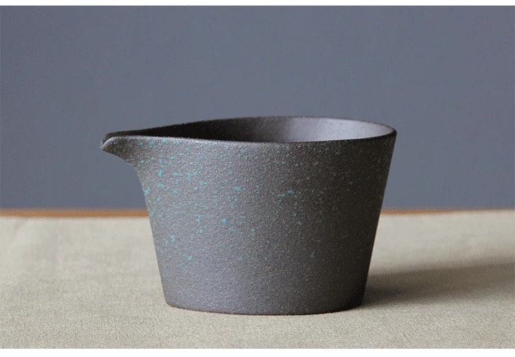 Minimalist ceramic creamer jug in soft natural tone on neutral background_gray color cup