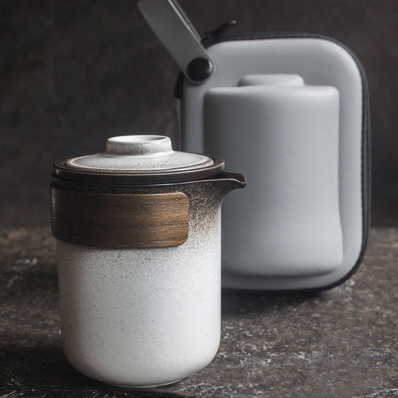 Portable tea set with kettle, stackable cups, and carry bag