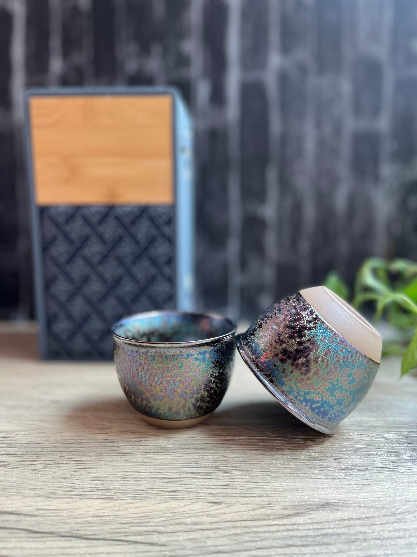 Side view of rainbow color mini cups placed beside bamboo box packaging with velvet cloth