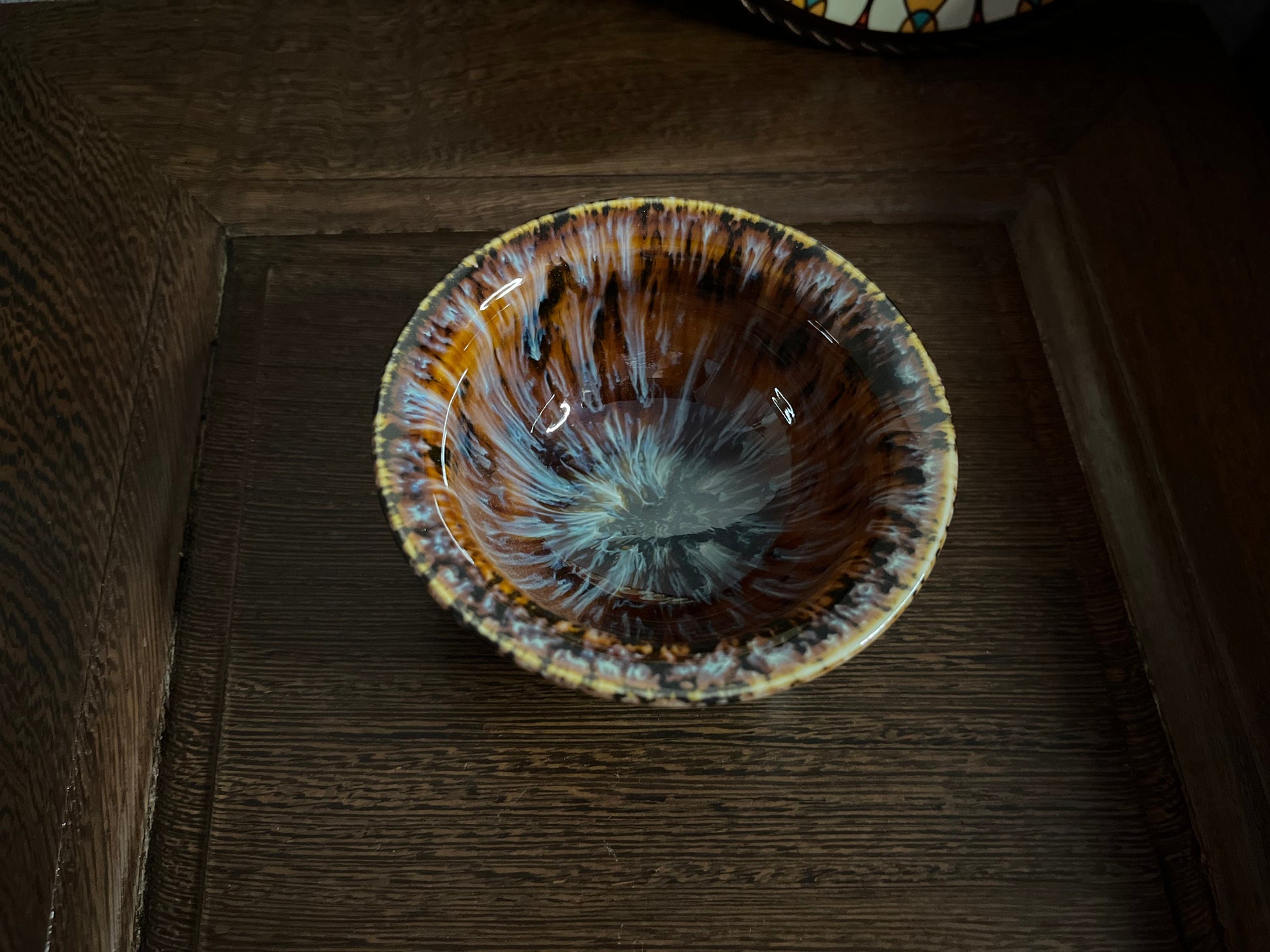Top view of Persian-inspired ceramic tea cup with arabesque pattern inside