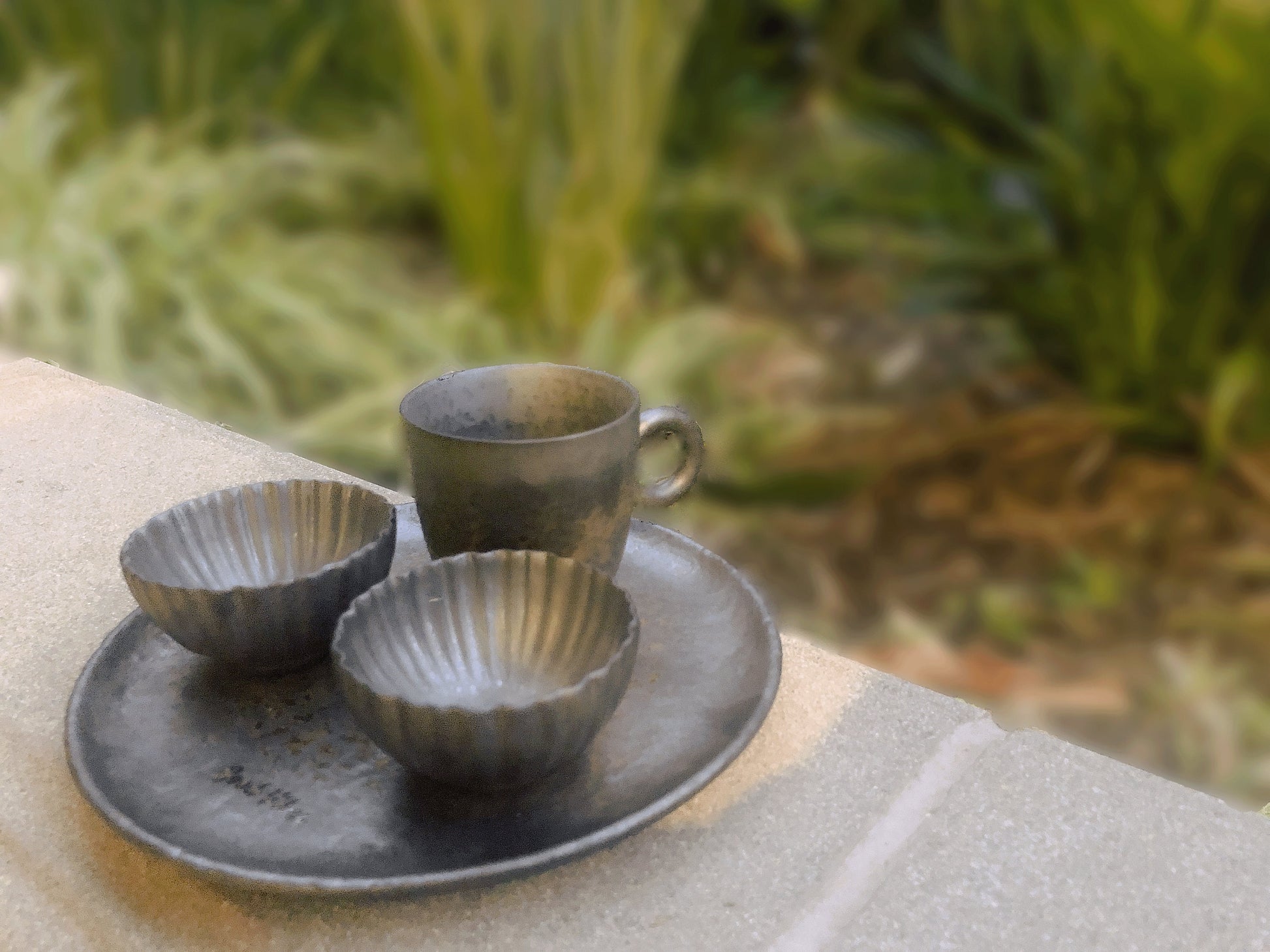 Vintage-inspired ceramic tea cup set displayed outdoors on matching tray