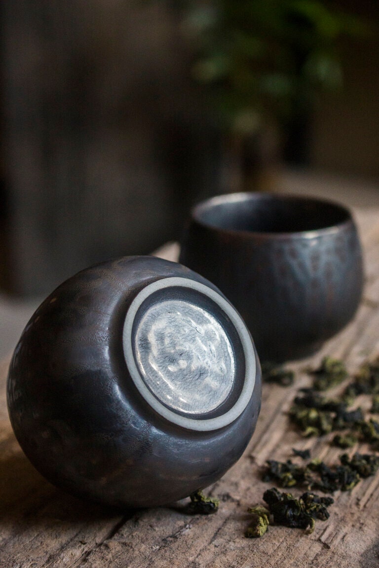 Vintage-inspired tea cups oval round shaped wine sake sipping cup, displayed on outdoor wooden surface