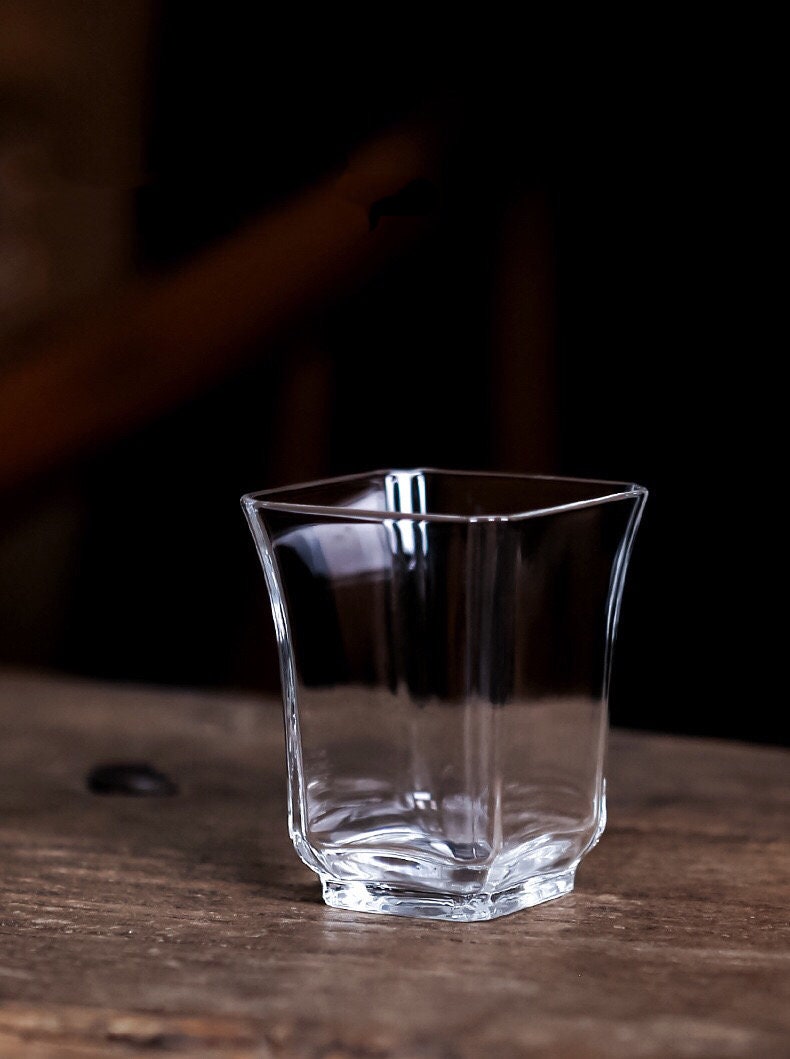 Zen style borosilicate glass drinkware mini cup displayed against dark background